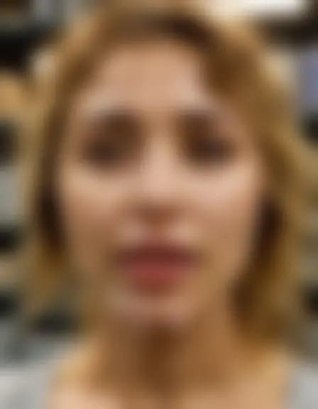 Abigail receives a facial cumshot in a compact stockroom.