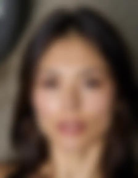 Avery enjoys a facial cumshot in a dimly lit, dilapidated service bay.