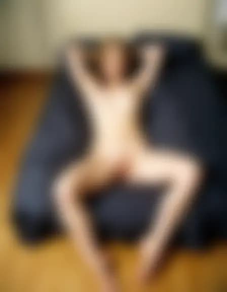 Zoe fingered herself in a cluttered masculine bedroom.