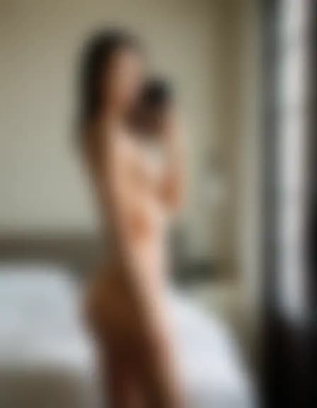 Chloe in a minimalist dorm room, intimate moment.