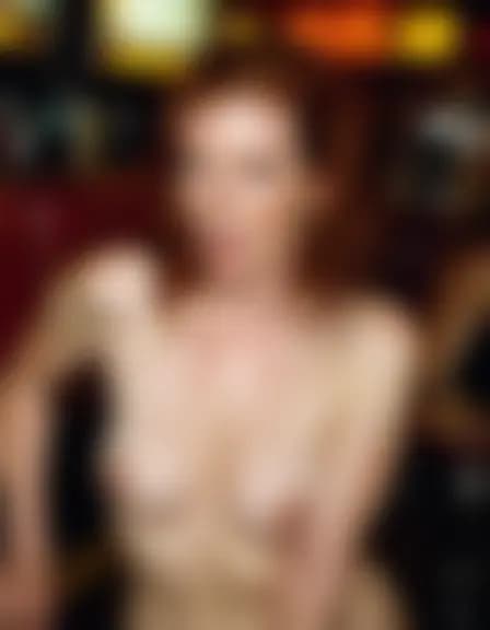 Evelyn enjoys a facial cumshot at a dimly lit bar.