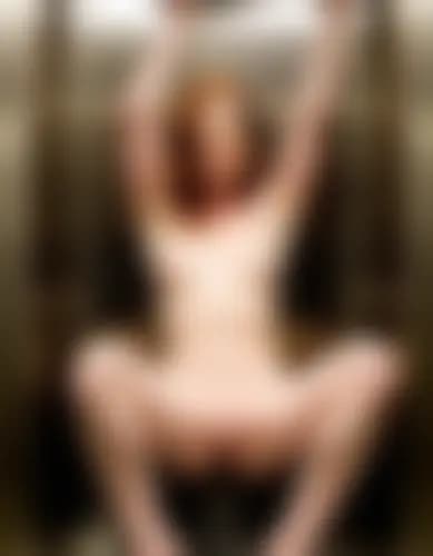 Evelyn fingers herself in a small, reflective elevator.