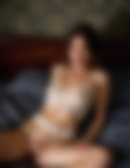 Lillian in a dark bedroom; rumpled sheets, smartphone.